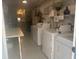 Functional laundry room equipped with multiple washing machines, shelving, and storage at 8455 112Th St # 202, Seminole, FL 33772