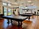 Recreation room showcasing multiple billiard tables, natural lighting, and exercise equipment at 8455 112Th St # 202, Seminole, FL 33772