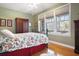 Comfortable bedroom with three windows overlooking a view, hardwood floors, and ceiling fan at 849 3Rd N St, St Petersburg, FL 33701