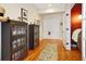 Inviting hallway features hardwood floors, glass door entry to a room with a red wall and furniture at 849 3Rd N St, St Petersburg, FL 33701