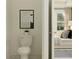 Cozy powder room with a modern toilet and a glimpse into a bedroom at 9296 Gladsome Dr, Land O Lakes, FL 34637
