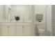 Bright bathroom with double vanity featuring white cabinets, marble countertops, and a toilet next to the tub at 9296 Gladsome Dr, Land O Lakes, FL 34637
