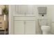 Bright bathroom features a vanity with white cabinets and a marble countertop next to a toilet at 9296 Gladsome Dr, Land O Lakes, FL 34637