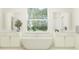 Luxurious bathroom featuring a soaking tub, dual vanities, and a bright window at 9296 Gladsome Dr, Land O Lakes, FL 34637