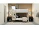 Shared bedroom features a white bunk bed, dark nightstands, stylish lamps, and a striped rug at 9296 Gladsome Dr, Land O Lakes, FL 34637