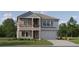 Charming two-story home with gray and blue siding, a two-car garage, and landscaped front yard at 9296 Gladsome Dr, Land O Lakes, FL 34637