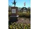 Charming Garden Party Park featuring a statue, flag, and gazebo in a lush garden setting at 9296 Gladsome Dr, Land O Lakes, FL 34637