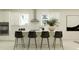 Bright, modern kitchen features a sleek island with bar seating and stainless steel appliances at 9296 Gladsome Dr, Land O Lakes, FL 34637