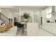 Open-concept kitchen with an island flowing into a living area with a staircase at 9296 Gladsome Dr, Land O Lakes, FL 34637
