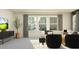 Bright and airy living area featuring a comfortable sofa, modern TV, and plenty of natural light at 9296 Gladsome Dr, Land O Lakes, FL 34637