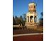 Picturesque community fountain featuring brick accents, decorative columns and water features in a manicured landscape at 9296 Gladsome Dr, Land O Lakes, FL 34637