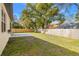 Spacious fenced backyard with a newly installed patio and plenty of room for gardening or recreation at 9310 N Willow Ave, Tampa, FL 33612