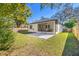 Inviting backyard with a screened patio, new stone hardscape, and a well-maintained lawn at 9310 N Willow Ave, Tampa, FL 33612