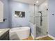 The bathroom is equipped with a large tub and stand up shower, perfect for relaxing at 9310 N Willow Ave, Tampa, FL 33612