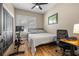 This bedroom features wood floors, a bed and a desk, perfect for work or relaxation at 9310 N Willow Ave, Tampa, FL 33612