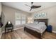 This bedroom features a ceiling fan, wood floors, and natural light from the window at 9310 N Willow Ave, Tampa, FL 33612