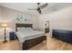 This bedroom has light wood floors, a large bed and opens to the bathroom at 9310 N Willow Ave, Tampa, FL 33612