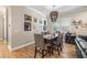 Formal dining room with modern chandelier, wood floors, and seating for six at 9310 N Willow Ave, Tampa, FL 33612