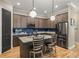 Modern kitchen with stainless steel appliances, granite countertops, and a stylish island with bar seating at 9310 N Willow Ave, Tampa, FL 33612