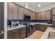Modern kitchen features granite countertops, a tile backsplash, and stainless steel appliances at 9310 N Willow Ave, Tampa, FL 33612