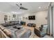 Spacious living room with comfortable leather seating, a ceiling fan, and a view into the dining area at 9310 N Willow Ave, Tampa, FL 33612