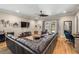 Spacious living room with comfortable leather seating, a ceiling fan, and access to the backyard at 9310 N Willow Ave, Tampa, FL 33612