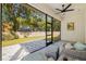 Relax on this screened patio with comfortable furniture and a view of the backyard at 9310 N Willow Ave, Tampa, FL 33612