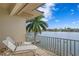 This waterfront balcony features views of the water, blue skies, and palm trees at 950 Monterey Ne Pt, St Petersburg, FL 33704