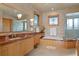 Bright bathroom features a marble countertop vanity, bathtub, and glass shower at 950 Monterey Ne Pt, St Petersburg, FL 33704