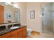 Bathroom with black countertop, vanity, large mirror, and a glass-enclosed shower at 950 Monterey Ne Pt, St Petersburg, FL 33704