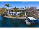 Beautiful waterfront property featuring a private dock and boat lift, complemented by lush landscaping at 950 Monterey Ne Pt, St Petersburg, FL 33704