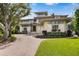 Stunning two-story home with lush landscaping, a circular driveway, and well-manicured lawn at 950 Monterey Ne Pt, St Petersburg, FL 33704