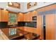 Modern kitchen featuring wood cabinets, black countertops, and stainless steel appliances at 950 Monterey Ne Pt, St Petersburg, FL 33704