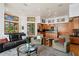 Inviting living room open to the kitchen, featuring hardwood floors, cozy seating, and large windows with lush green views at 950 Monterey Ne Pt, St Petersburg, FL 33704