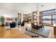 Open-concept living space with a dining area, piano, and expansive windows providing stunning water views, perfect for entertaining at 950 Monterey Ne Pt, St Petersburg, FL 33704