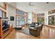 Cozy living room with hardwood floors, ample seating, and large windows showcasing beautiful views of the water and greenery at 950 Monterey Ne Pt, St Petersburg, FL 33704