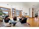 Bright and spacious living area with hardwood floors, a piano, and multiple windows offering picturesque views of the water at 950 Monterey Ne Pt, St Petersburg, FL 33704