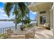 Inviting outdoor patio with a dining table and chairs, perfect for enjoying waterfront views at 950 Monterey Ne Pt, St Petersburg, FL 33704