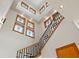 Bright staircase with black metal railing, hardwood steps, and abundant natural light from clerestory windows at 950 Monterey Ne Pt, St Petersburg, FL 33704