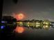 Nighttime view of waterfront homes reflecting on the water, with a vibrant fireworks display illuminating the sky at 950 Monterey Ne Pt, St Petersburg, FL 33704