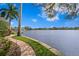 Scenic waterfront property with a brick path, lush lawn, and the expansive lake beyond at 950 Monterey Ne Pt, St Petersburg, FL 33704