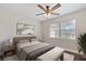 Cozy bedroom with a large window, ceiling fan, and comfortable bed at 9845 84Th Way, Seminole, FL 33777