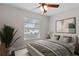 Bright bedroom with large window and comfortable furnishings, featuring stylish decor at 9845 84Th Way, Seminole, FL 33777