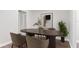 A dining room with a modern table and chairs, complemented by stylish decor and natural light at 9845 84Th Way, Seminole, FL 33777