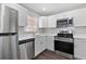 Bright kitchen featuring white cabinets, stainless steel appliances, and modern countertops at 9845 84Th Way, Seminole, FL 33777