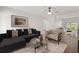 Inviting living room featuring a plush sofa, modern artwork, and a bright, airy ambiance at 9845 84Th Way, Seminole, FL 33777