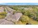 Aerial view of townhomes with lush landscaping and a serene pond at 11162 Windsor Place Cir, Tampa, FL 33626