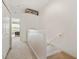 Hallway with carpet and closet. Stairs lead down to a lower level, and a bedroom is visible in the background at 11162 Windsor Place Cir, Tampa, FL 33626