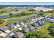 Stunning aerial view of the neighborhood with mature trees, serene ponds, and community spaces at 11486 June Briar Loop, San Antonio, FL 33576