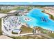 Aerial view of a lagoon with clear blue water, sandy beaches, and water attractions at 11486 June Briar Loop, San Antonio, FL 33576